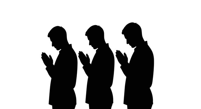 Muslim men praying in silhouette.
