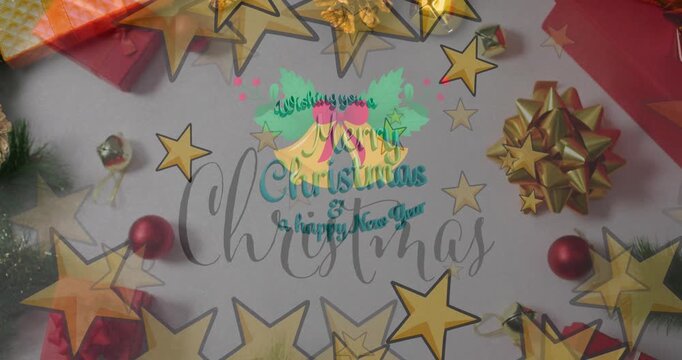 Animation of christmas greetings text over christmas presents and decorations