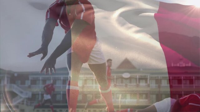 Rugby players tackling and passing on field with waving flag animation overlay