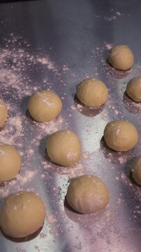 Kneading the pie dough. A woman rolls out the dough in the kitchen.