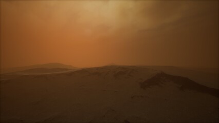 Fototapeta premium A stunning sunset casts warm orange and brown hues across an expansive desert. Silhouetted mountains rise in the background, creating an otherworldly atmosphere.