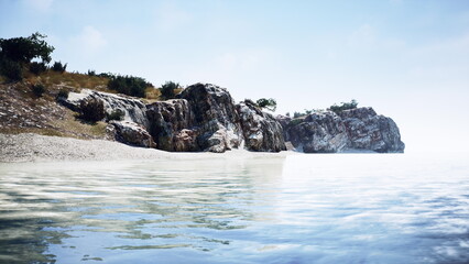 Soft light cascades over the quiet waters, revealing a rugged coastline adorned with gentle waves. Nature embraces the peace of early morning with lush greenery and rocky formations. © icetray
