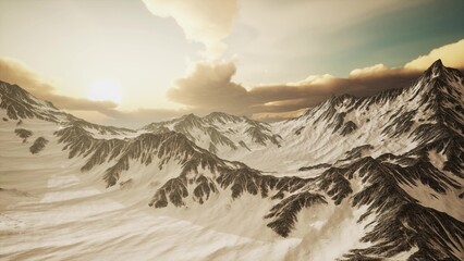 Golden sunlight cascades over towering snow capped mountains, highlighting jagged peaks and valleys. Clouds drift gently, adding depth to the breathtaking landscape at dusk. © icetray