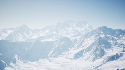 Obraz premium Towering peaks blanketed in fresh snow stretch across the horizon, reflecting the bright sunlight. The tranquil landscape offers a sense of peace and beckons exploration in winters embrace.