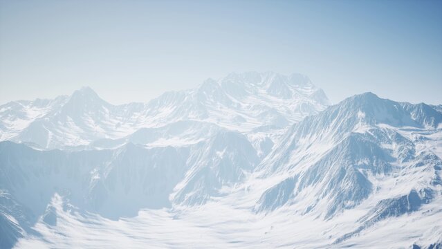 Towering peaks blanketed in fresh snow stretch across the horizon, reflecting the bright sunlight. The tranquil landscape offers a sense of peace and beckons exploration in winters embrace.