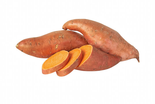 Fresh whole and sliced sweet potatoes showing vibrant orange interior