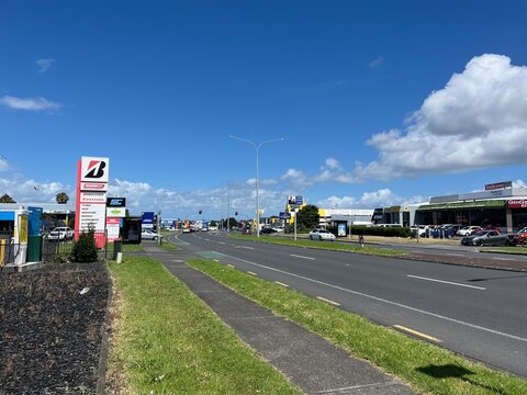 Bridgestone Select and Firestone tire service station signage along a busy commercial road with parked cars and local retail shops in Manukau - Auckland, New Zealand, February 8, 2023