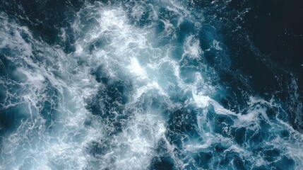 Fototapeta premium Top-down view of the sea, showing the texture of waves and light reflections, suitable for use in branding for marine products, or as a background for wellness content.