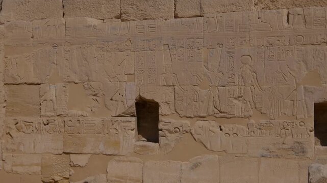 Close-up of detailed hieroglyphic rows with cartouches carved in stone lintel at Seti I temple Luxor Egypt.