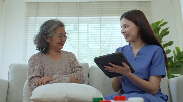 Caregiver elderly care home nurse senior support consultation tablet healthcare conversation on sofa, provider reviews digital record, warm smile, care plan review and advice, trust and comfort
