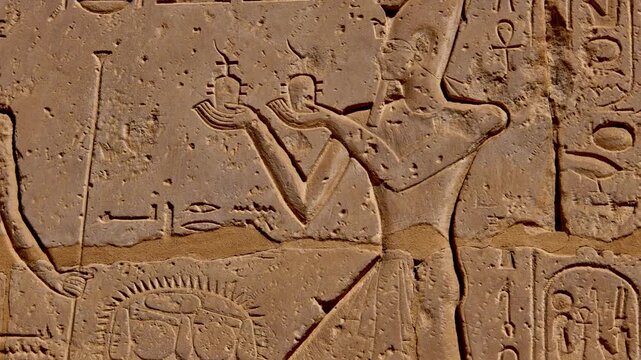 Close-up of detailed hieroglyphic rows with cartouches carved in stone lintel at Seti I temple Luxor Egypt.