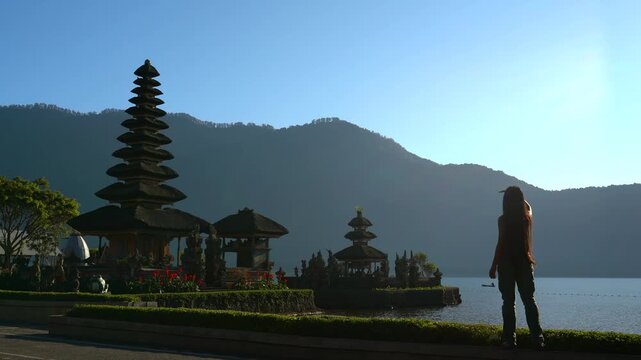 Beautiful girl visiting the ulun danu bratan temple in Bali.
