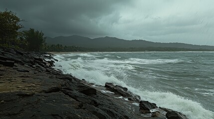 Fototapeta premium Crashing ocean waves against a rocky coast under an overcast stormy sky, showcasing nature's raw power and coastal erosion.