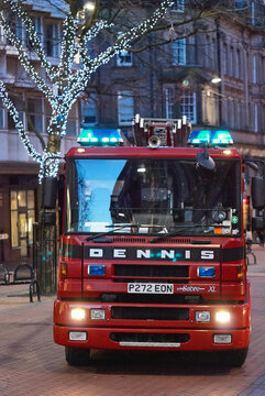 Dennis Sabre XL fire engine with emergency lights active on a city street, Birmingham, West Midlands, England, UK.
