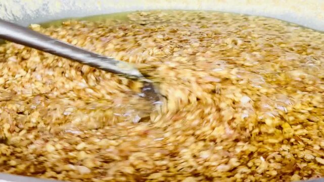 A close-up image of minced garlic frying in piping hot oil, bubbling violently until it turns golden brown and crispy. This captures the beautiful texture, movement, and color of this traditional Th