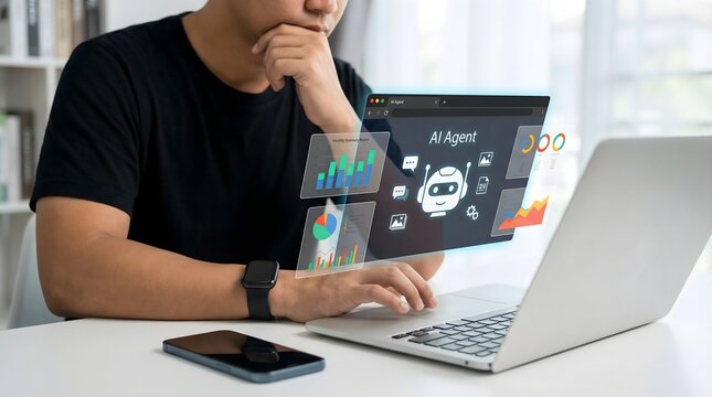 Man using laptop with graphic design software and ai tools in a bright workspace