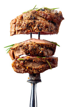 Beef steak on a fork isolated on a white background.