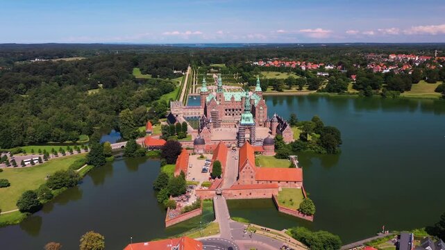 Aerial view of Frederiksborg castle in Hillerod Denmark during sunny summer day with majestic architecture and lake
