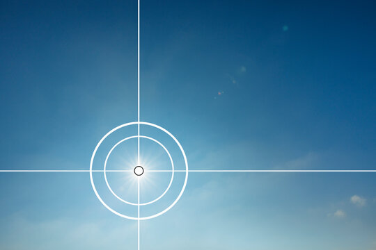 Fadenkreuz vor einer Sonne in einem blauen Himmel
