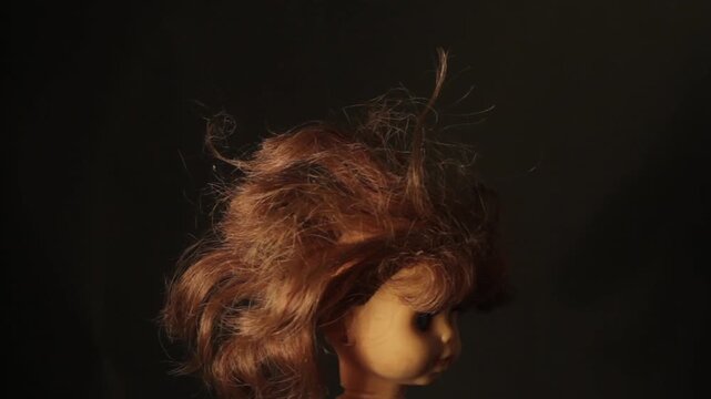 old doll head spinning isolated on black loop 