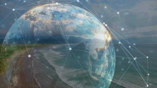 Aerial beach shot fading into rotating transparent globe pulsing nodes tracing network connections