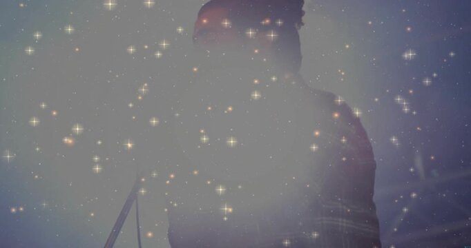 Concert singer stepping to mic singing, captivating audience while sparkle overlay grows denser