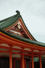 Fototapeta premium Traditional Japanese temple roof detail against pale sky