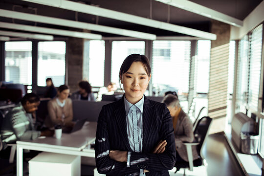 Portrait of confident young businesswoman in modern open office