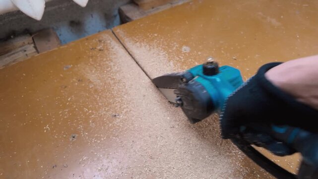 Using Saw To Trim Floor Edges Carefully. Oscillating Saw Used To Cut Flooring Seam Precisely. Operator Carefully Trims Floor Seam With Oscillating Saw For New Flooring Installation