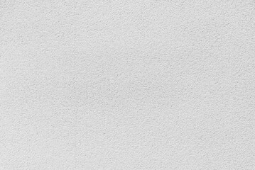 Naklejka premium Close up of a clean white concrete wall with a fine rough texture surface. concept of minimalist background, architectural material, bright plaster finish, construction detail and modern interior.
