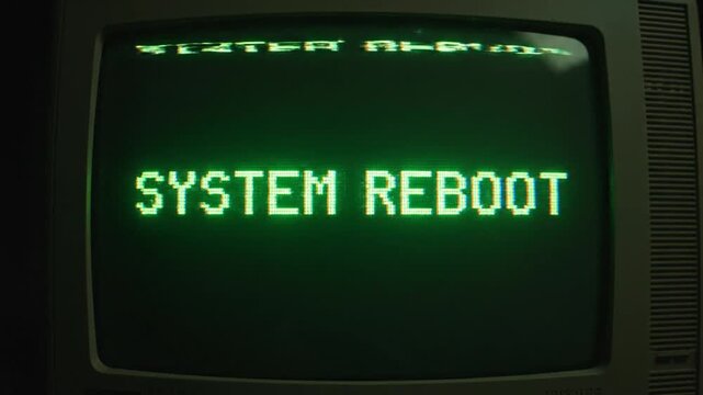 Close up. Old CRT monitor screen displaying distorted green SYSTEM REBOOT text. Heavy digital glitch, scanlines, interference. Retro technology.