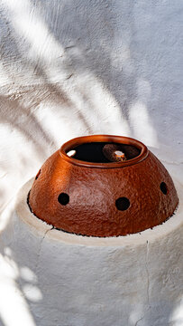Iron pot on white curved wall at LagOmar in Lanzarote