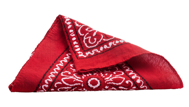 Isolated folded red cotton bandana with classic white and black paisley pattern and textile detail