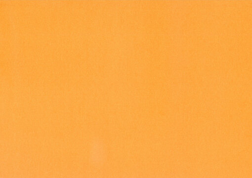 Light orange surface of thick paper or cardboard, background, texture. Backdrop of paper surface with small pattern. Terracotta, light-brown textured paper piece. Smooth paper surface of ginger color