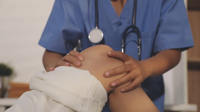 physiotherapist exam patient's knee. Senior patient with knee injury visit his physiotherapist
