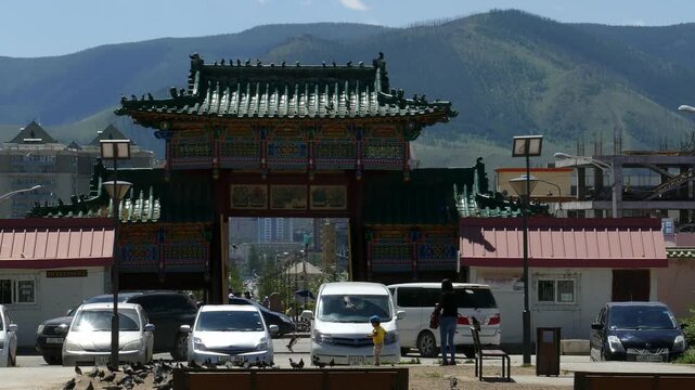 Ulaanbaatar, Mongolia - 26 july 2017: The Mongolian monastery Gandantegchinlen. The main gate in the form of a pagoda against the backdrop of picturesque mountains on a summer sunny day.