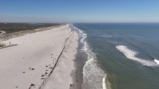 Aerial coastline view of a long stretch of sandy beach near Anastasia State Park in St Augustine, Florida. 