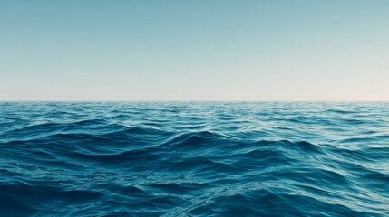 Fototapeta premium Serene Blue Waves Under a Calm Horizon with a Minimalist Background at Golden Hour