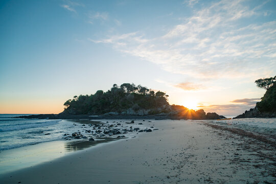 Sun rising behind Hedgehog Island at Seal Rocks