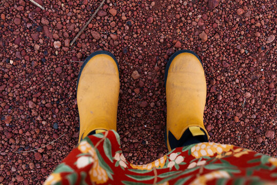 bright yellow boots on red gravel stones in inland Australia