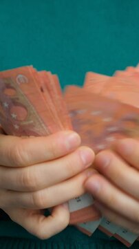 Macro video of finger counting ten Euro paper banknotes.