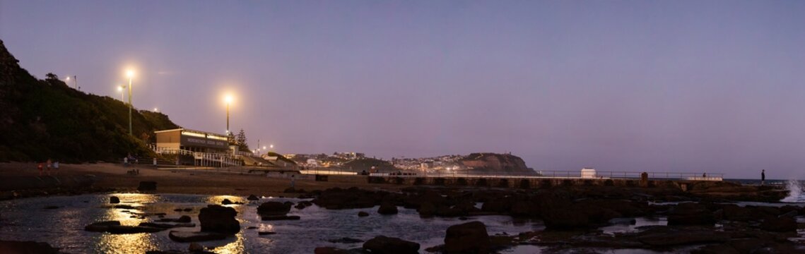 Merewether Ocean Baths coastal landscape at nightfall looking towards Nobbys Head