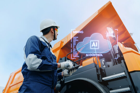 Mining site worker using tablet with AI technology assistant with chat cloud overlay for mining equipment monitoring industrial