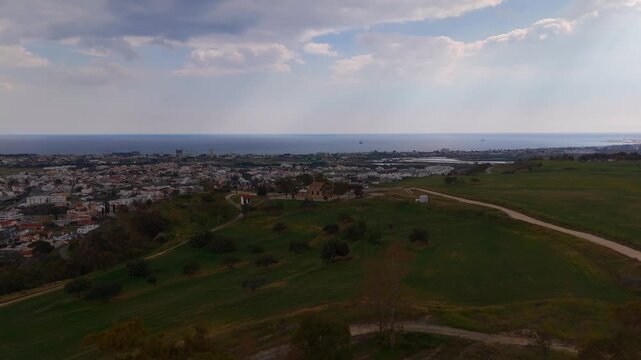 Wide Aerial Orbit of Historic Prophet Illias Church on Terraced Hillside Oroklini Cyprus
