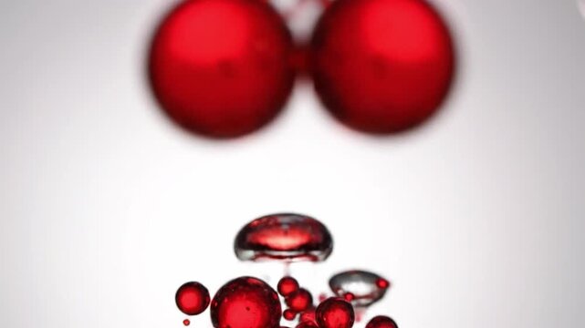 Close Up of Red Bubbles Floating and Merging in Water