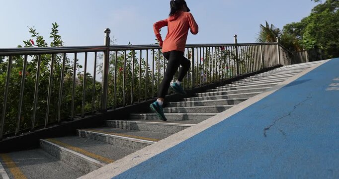 Fitness sports woman running up stairs in city