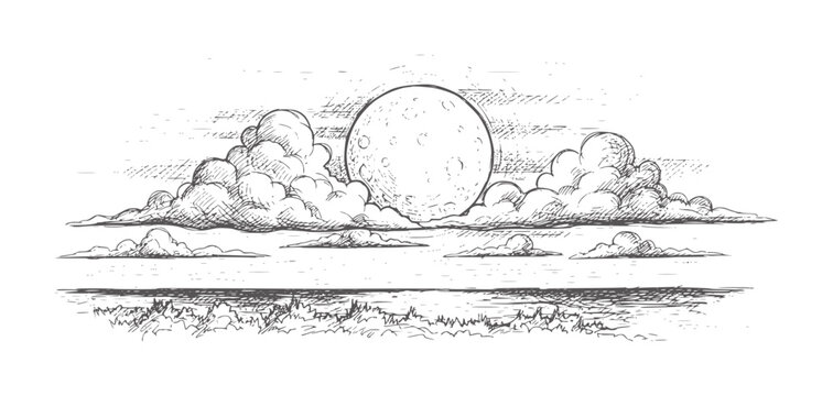 Full moon rising above clouds over grassy landscape