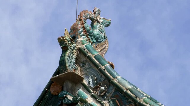 Bird sits on the roof of an ancient Buddhist pagoda, decorated with figures of mythical animals. One of the temples of  Erdene Zuu monastery, Kharkhorin, Mongolia.