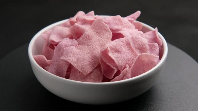 Purple sweet potato Crackers,Deep fried thin slices of rice flour purple yam flavour,crisp rice cakes in white bowl.