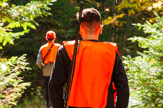 Young hunters scouring a forest trail in autumn in search of prey